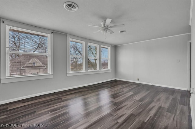 2101 N I St, Fort Smith, AR 72901 - empty room featuring dark wood finished floors, a ceiling fan, and baseboards