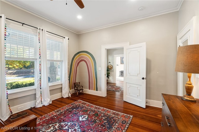 sitting room featuring ceiling fan, dark hardwood / wood-style flooring, and crown molding