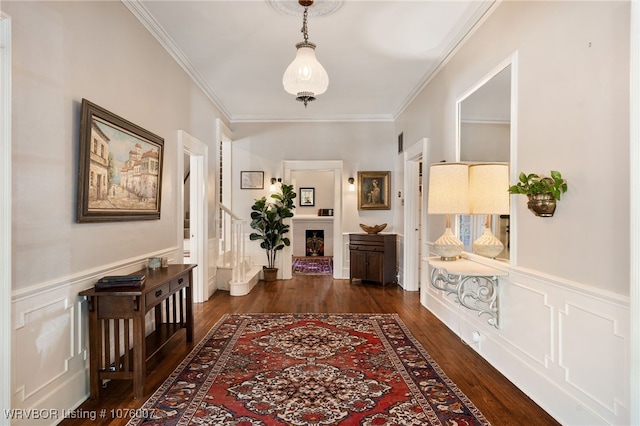 hall with dark hardwood / wood-style floors and ornamental molding