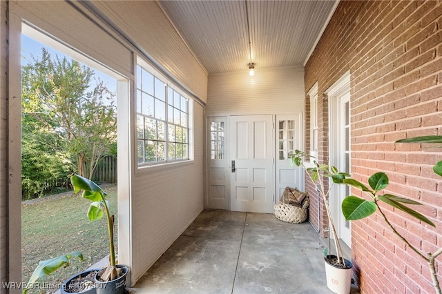 unfurnished sunroom with wood ceiling