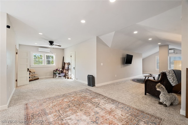 carpeted living room with ceiling fan, lofted ceiling, and a wall unit AC