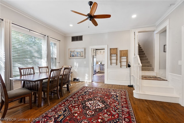 dining area featuring crown molding, ceiling fan, and dark wood-type flooring