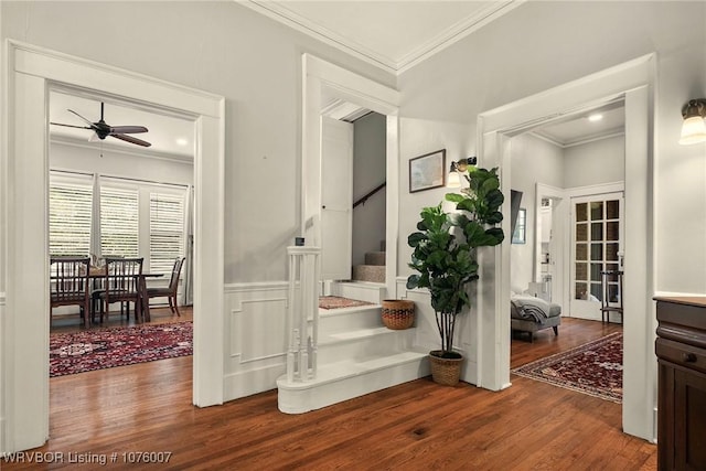 interior space featuring ceiling fan, hardwood / wood-style floors, and ornamental molding