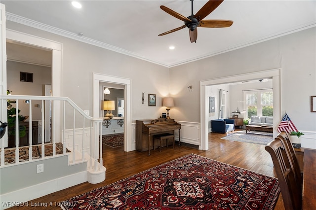 interior space featuring ceiling fan, crown molding, and dark wood-type flooring