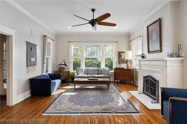 living room featuring hardwood / wood-style floors, ceiling fan, and ornamental molding