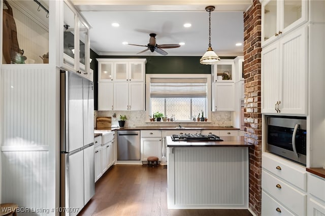 kitchen featuring backsplash, ceiling fan, white cabinetry, and stainless steel appliances