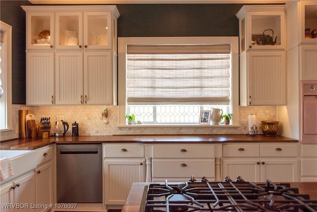 kitchen featuring white cabinets, backsplash, and stainless steel appliances