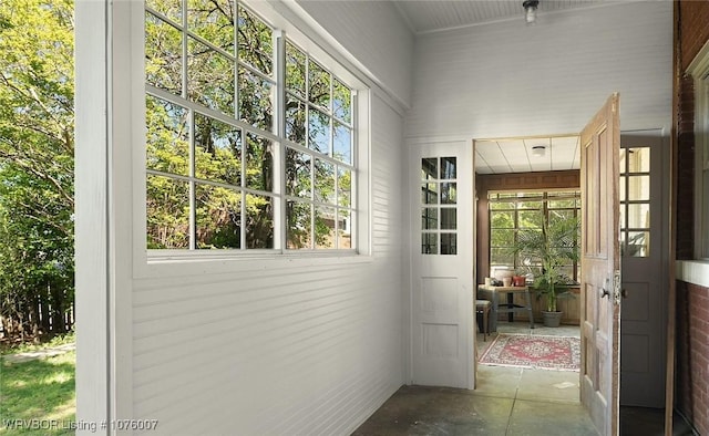 doorway to outside featuring concrete floors