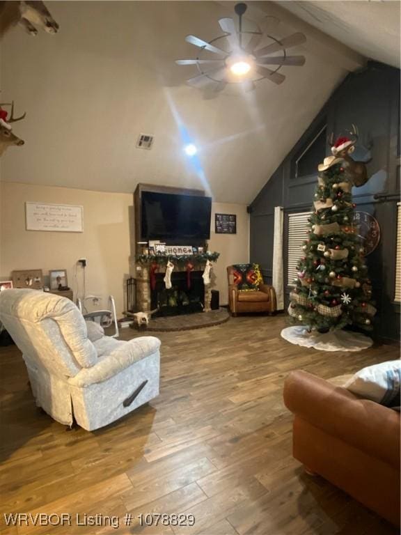 living room featuring beamed ceiling, ceiling fan, high vaulted ceiling, and hardwood / wood-style floors