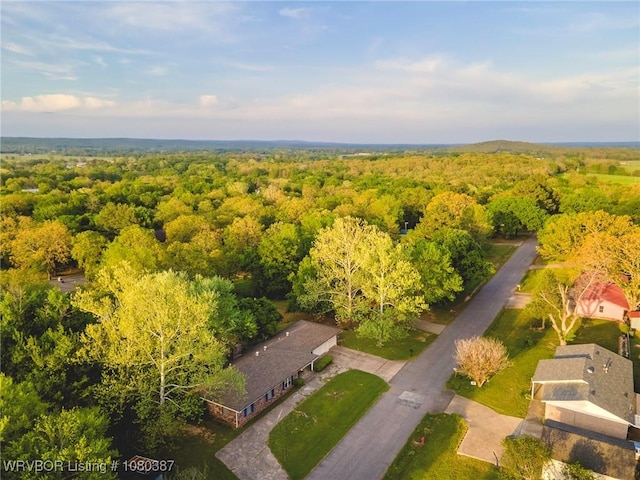 birds eye view of property with a wooded view
