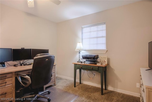 carpeted office featuring ceiling fan and baseboards