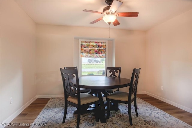 dining area featuring baseboards, wood finished floors, and ceiling fan