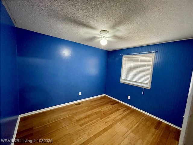 2119 55th Pl, Fort Smith, AR 72904 - spare room with a ceiling fan, wood finished floors, and a textured ceiling