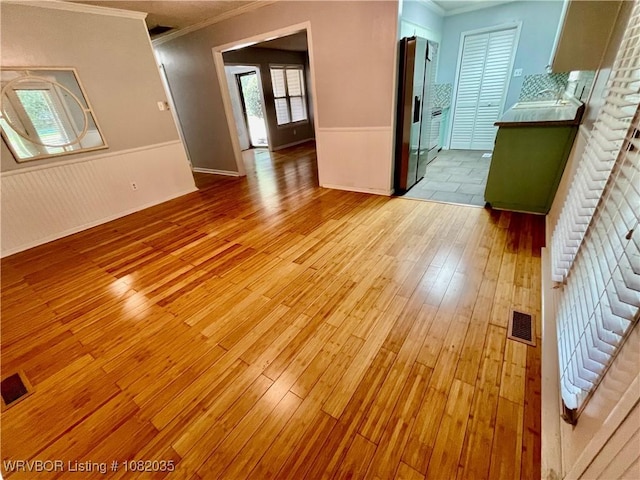 2119 55th Pl, Fort Smith, AR 72904 - spare room featuring ornamental molding, light wood-style flooring, and wainscoting