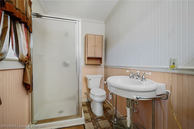 bathroom featuring crown molding, toilet, wood walls, and walk in shower