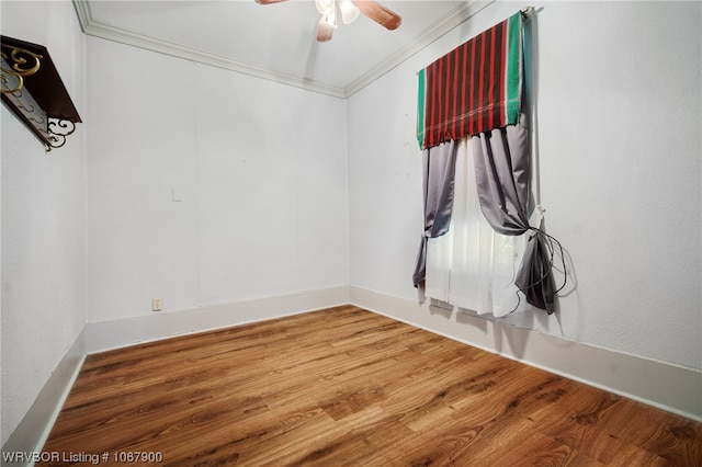 spare room featuring hardwood / wood-style flooring, ceiling fan, and ornamental molding