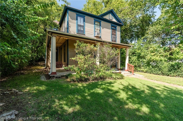 back of house featuring cooling unit and a lawn