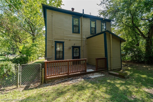 back of house with a lawn and a deck