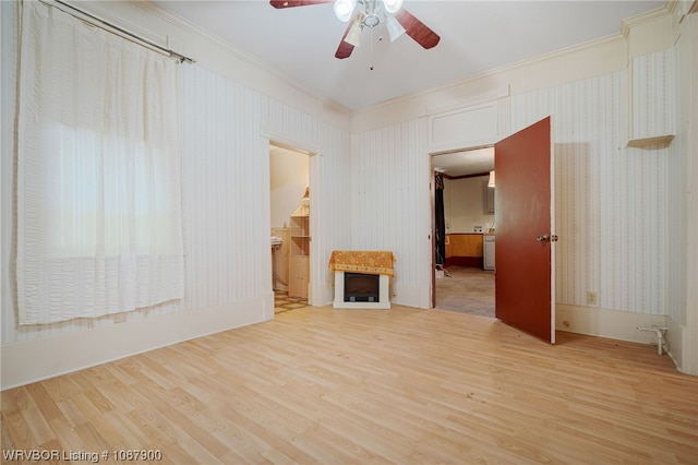 spare room featuring crown molding, hardwood / wood-style floors, and ceiling fan