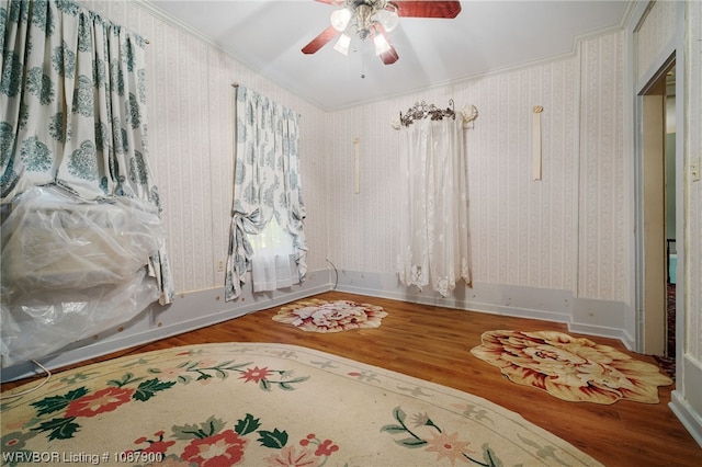 spare room with hardwood / wood-style flooring, ceiling fan, and ornamental molding