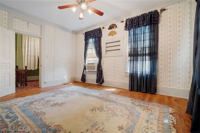 unfurnished room with hardwood / wood-style flooring, ceiling fan, cooling unit, and ornamental molding