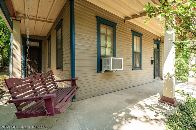 view of side of home featuring cooling unit and a porch