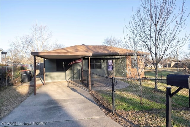 view of front of home featuring a carport, driveway, and fence