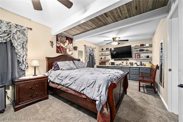 carpeted bedroom with beamed ceiling, baseboards, and a ceiling fan