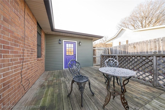 wooden terrace featuring fence