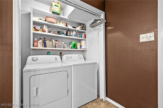 laundry room with laundry area, independent washer and dryer, baseboards, and a textured wall