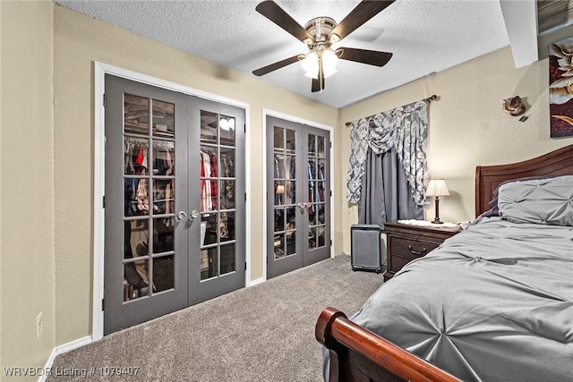 bedroom with french doors, a textured ceiling, carpet flooring, and a textured wall