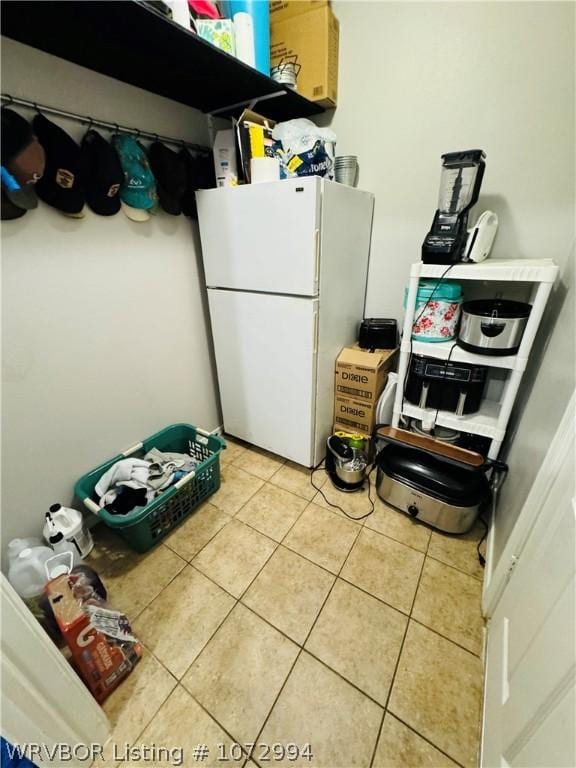 clothes washing area with tile patterned floors