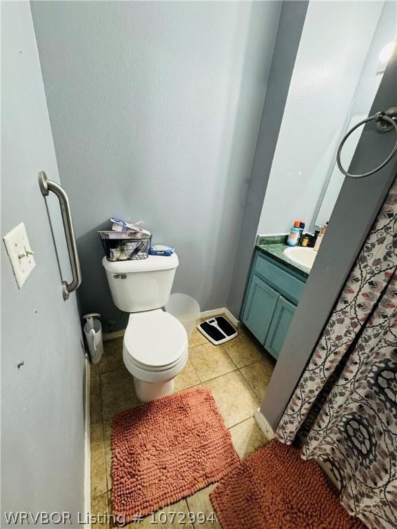 bathroom with tile patterned floors, vanity, and toilet