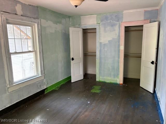 unfurnished bedroom featuring multiple windows