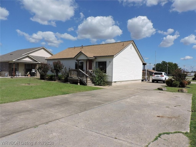 ranch-style house featuring concrete driveway, a front lawn, and crawl space