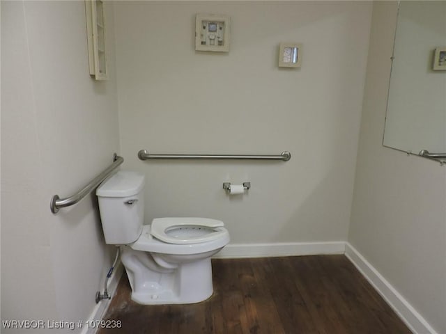 half bath with wood finished floors, toilet, and baseboards