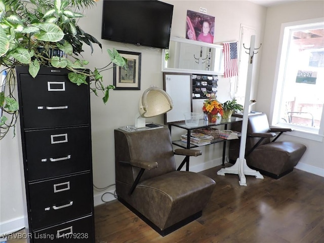 sitting room featuring baseboards and wood finished floors