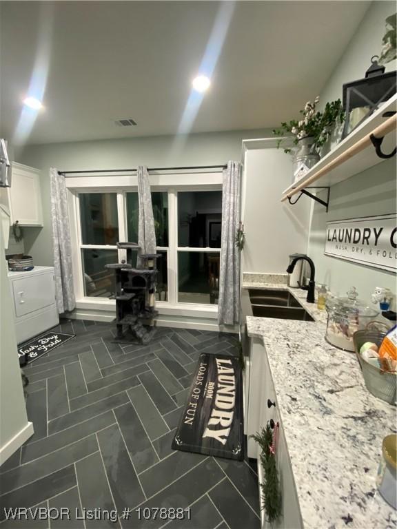 interior space with washer / clothes dryer and sink