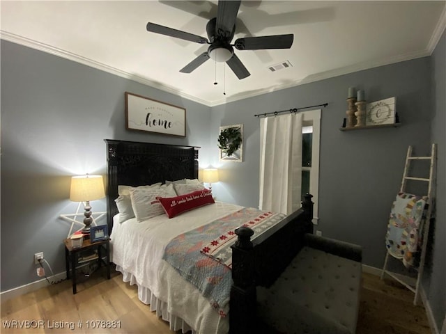 bedroom featuring hardwood / wood-style flooring, ornamental molding, and ceiling fan