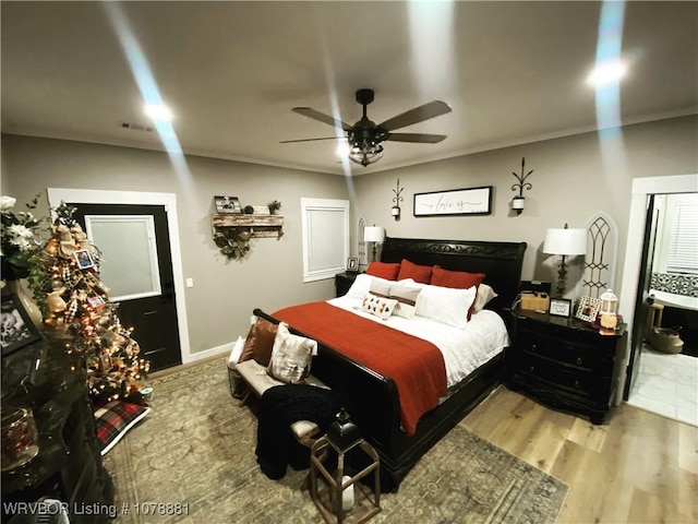 bedroom featuring ornamental molding, ceiling fan, and light hardwood / wood-style flooring