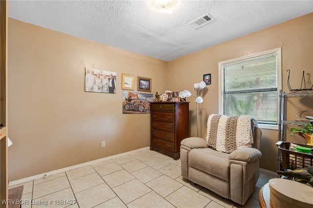 3500 N 48th St, Fort Smith, AR 72904 - living area with a textured ceiling, baseboards, and light tile patterned floors