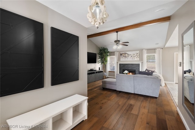 living room with vaulted ceiling with beams, dark hardwood / wood-style flooring, a fireplace, and ceiling fan with notable chandelier