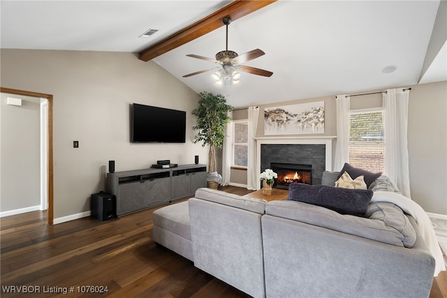 living room with vaulted ceiling with beams, ceiling fan, dark hardwood / wood-style flooring, and a tile fireplace