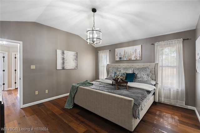 bedroom with dark hardwood / wood-style floors, an inviting chandelier, multiple windows, and lofted ceiling