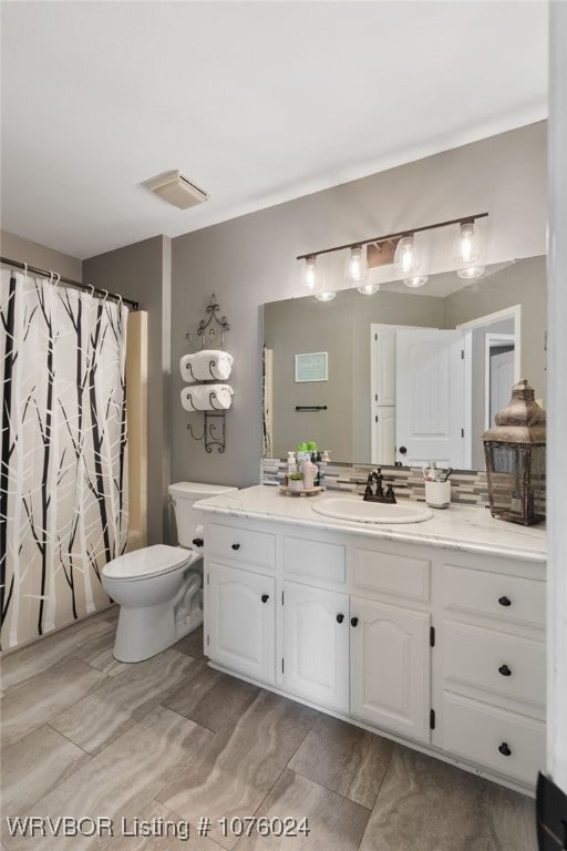 full bathroom with vanity, toilet, and shower / bath combo with shower curtain