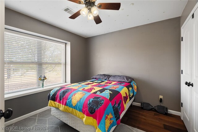 bedroom with ceiling fan and a closet