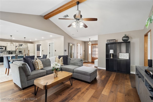 living room featuring hardwood / wood-style floors, vaulted ceiling with beams, and ceiling fan