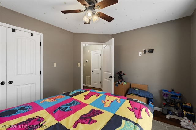 bedroom with ceiling fan and a closet