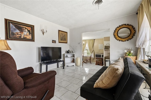 living area with visible vents and a textured ceiling