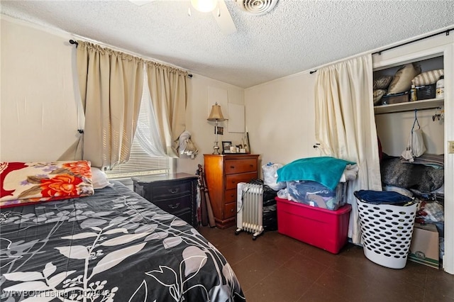 bedroom featuring radiator heating unit, visible vents, ceiling fan, and a textured ceiling